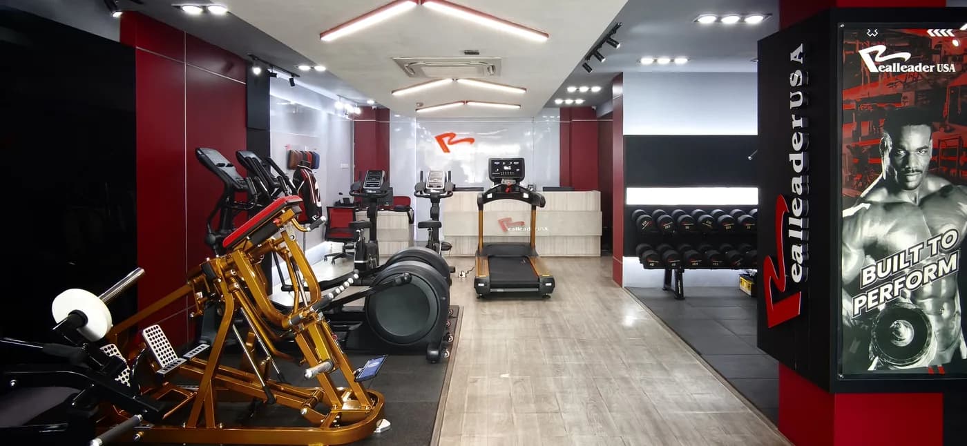 Commercial fitness centre floor with a row of RealleaderUSA training machines